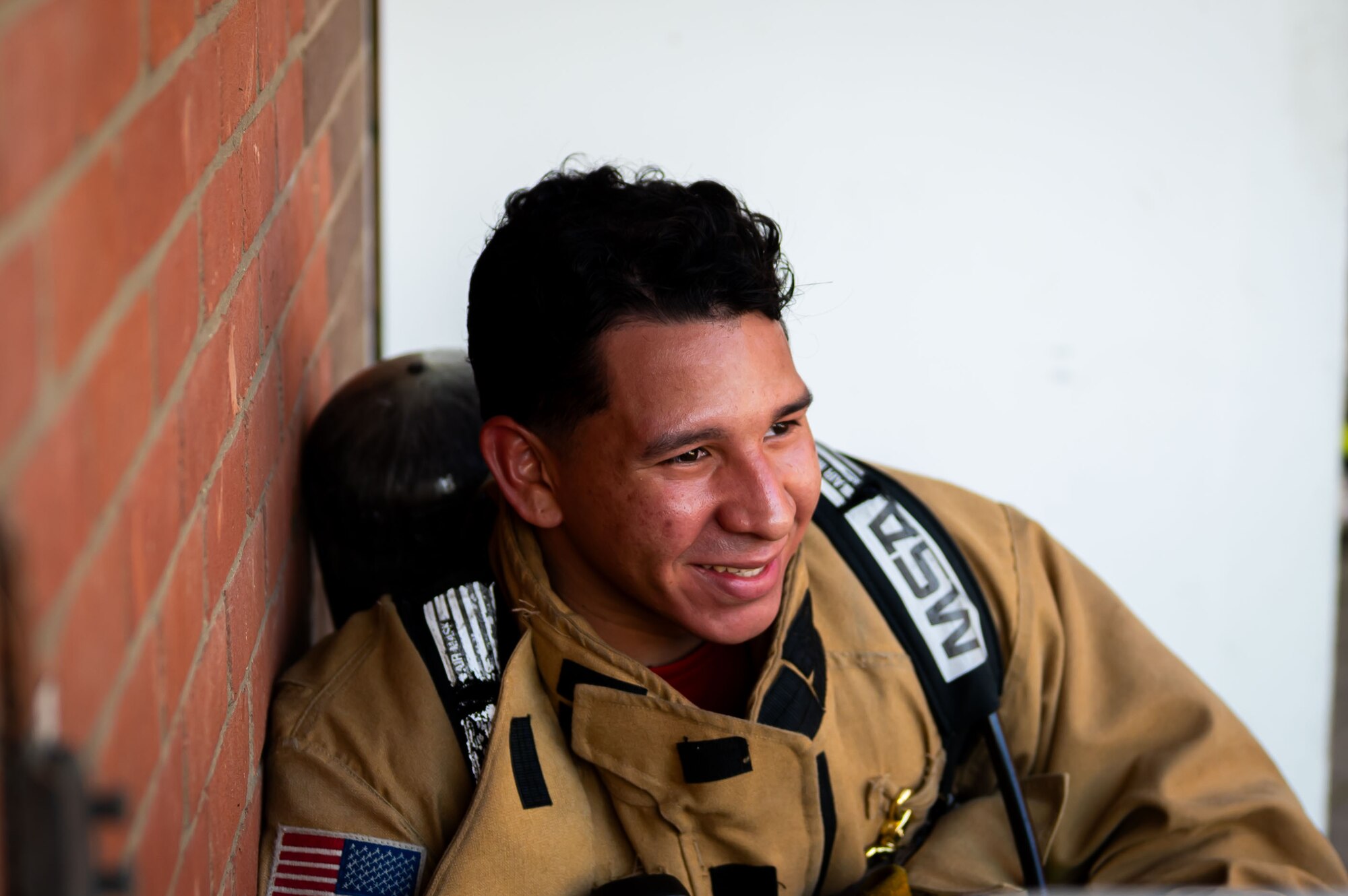 U.S. Air Force Airman 1st Class Jeniel De Jesus Ponce, 100th Civil Engineer Squadron firefighter, rests at the bottom of the air traffic control tower at RAF Mildenhall, England, Sept. 11, 2025.