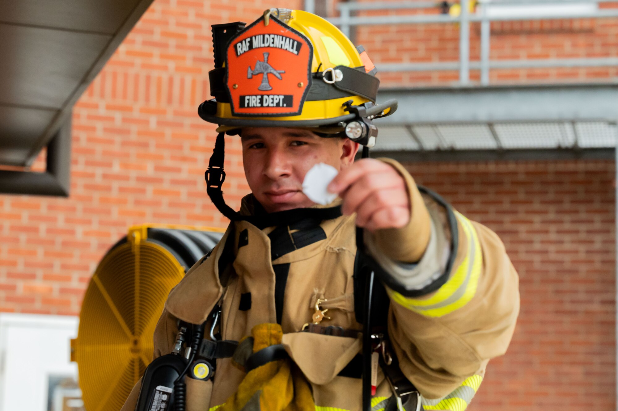 U.S. Air Force Airman 1st Class Jeniel De Jesus Ponce, 100th Civil Engineer Squadron firefighter, poses for a picture at the bottom of the air traffic control tower at RAF Mildenhall, England, Sept. 11, 2025