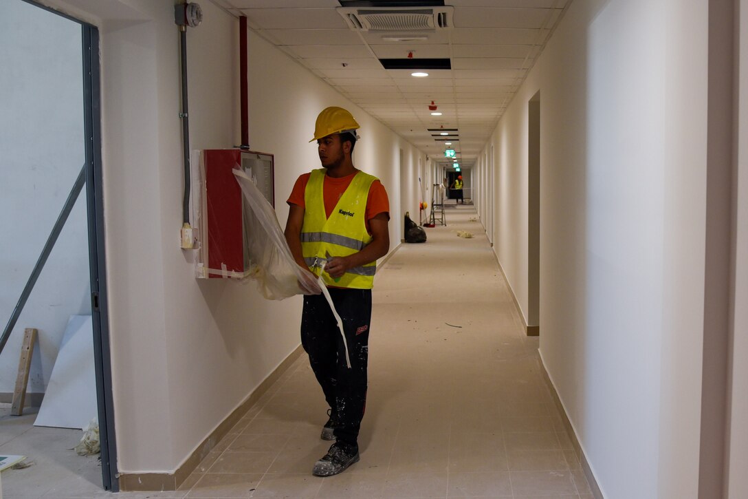 two men working in a hallway