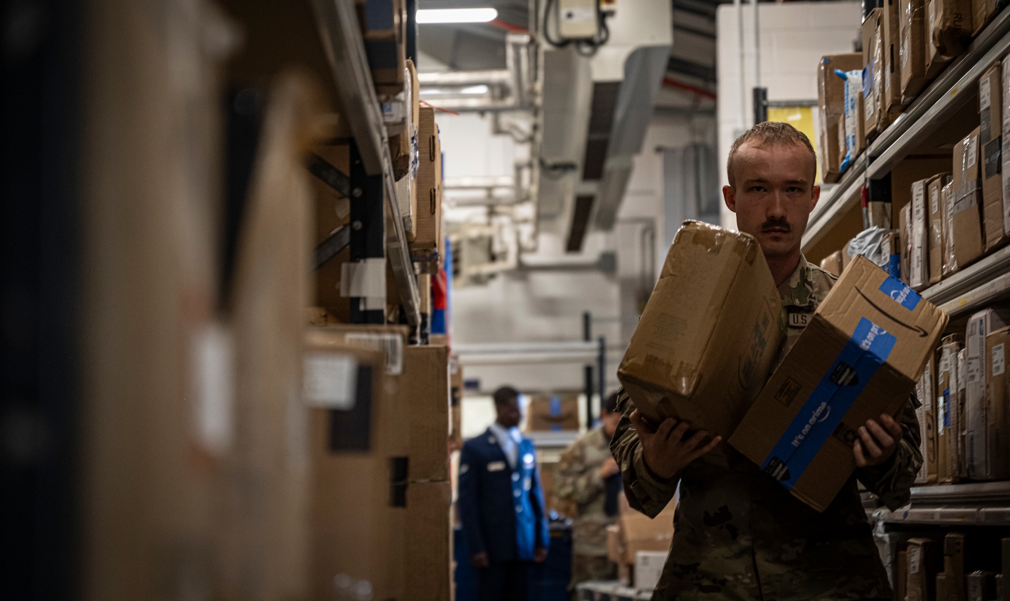 U.S. Air Force Senior Airman Michael Jones, 100th Force Support Squadron postal clerk transfers packages to customer shelving at RAF Mildenhall, England, Sept. 19, 2025.