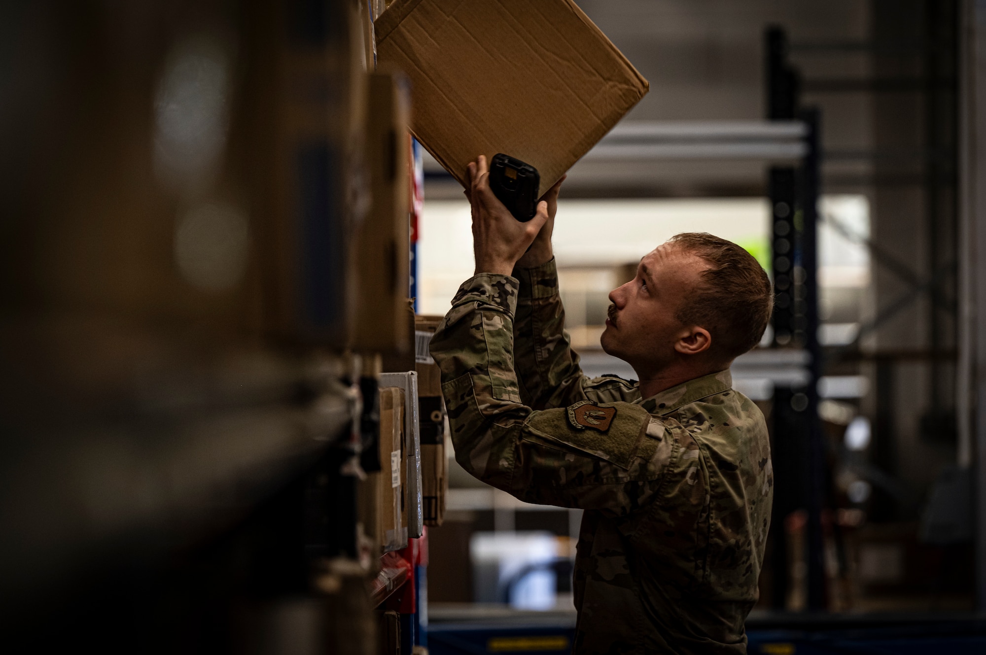 U.S. Air Force Senior Airman Michael Jones, 100th Force Support Squadron postal clerk, retrieves a package for a customer at RAF Mildenhall, England, Sept. 19, 2025.