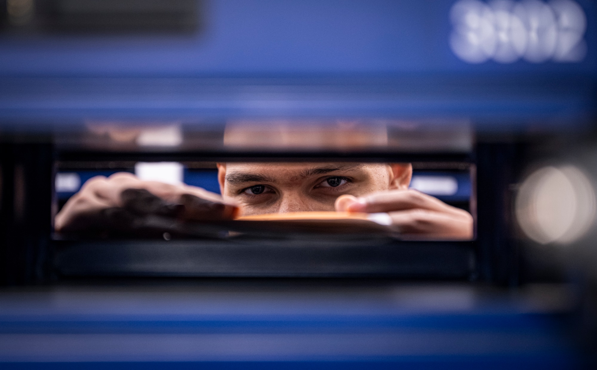 U.S. Air Force Airman 1st Class Trenton Hurley, 100th Force Support Squadron postal clerk, inserts envelopes into a customer’s post office box at RAF Mildenhall, England, Sept. 19, 2025.