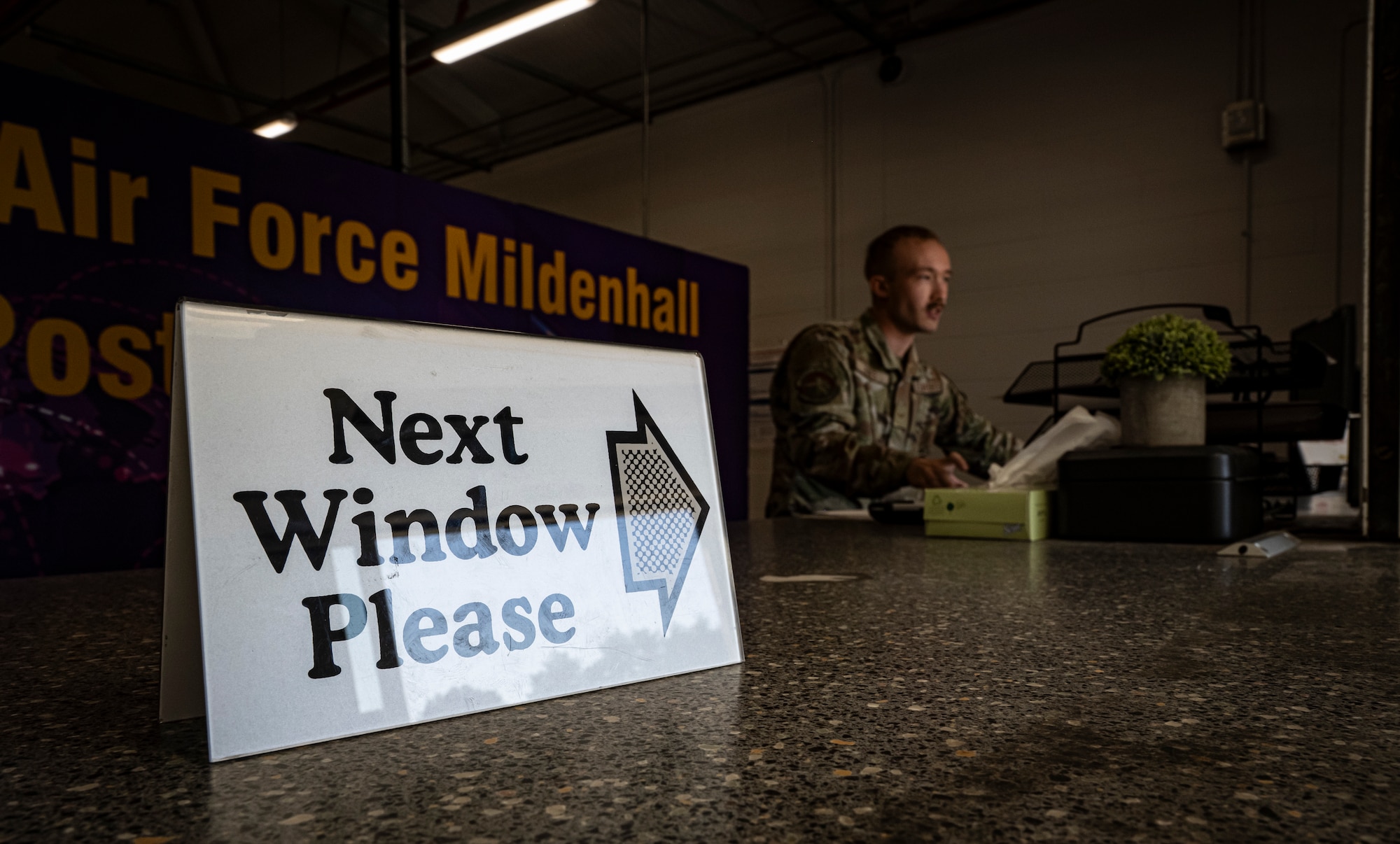 U.S. Air Force Senior Airman Michael Jones, 100th Force Support Squadron postal clerk, greets customers at the front counter at RAF Mildenhall, England, Sept. 19, 2025.