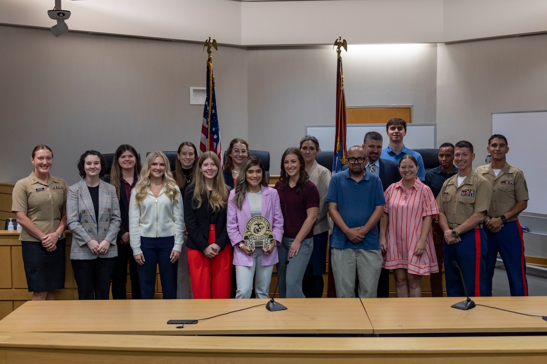 U.S. Marines and students and faculty with Bowen Law School pose for a group photo following the Marine Corps Opening Statements Competition at Bowen Law School, Little Rock, Arkansas, Sep. 12, 2025. The Marine Corps hosted an opening statements competition at Bowen Law School to better connect with future legal professionals and showcase the opportunities available as a Marine Corps Judge Advocate. (U.S. Marine Corps photo by Staff Sgt. Lennon Dregoiw)