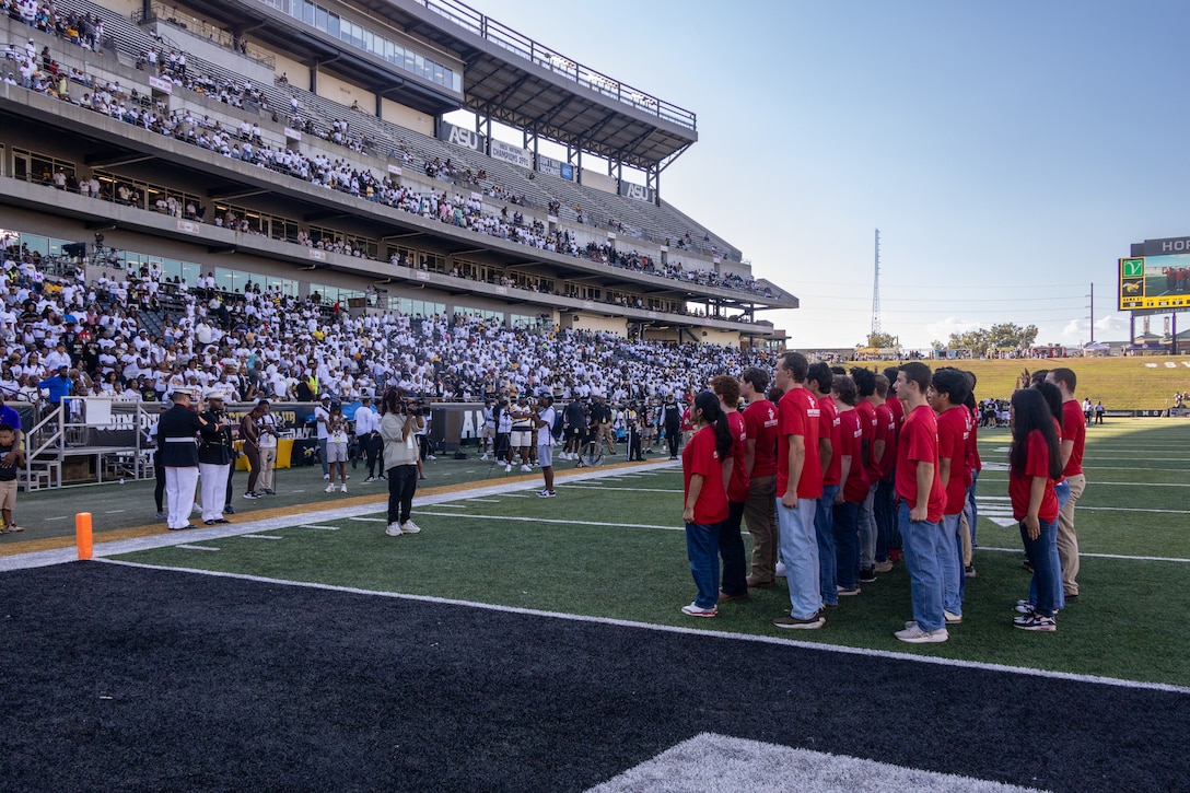U.S. Marine Corps Capt. Bobby Robinson, officer selection officer assigned to Recruiting Station Montgomery, issues the oath of enlistment to enlisted applicants and officer candidates across the state of Alabama and Mississippi during the Alabama State University Football's home opener vs Miles College on Sept. 13, 2025. This game is otherwise known as the Magic City Classic. (U.S. Marine Corps photo by Sgt. Ruben Padilla)