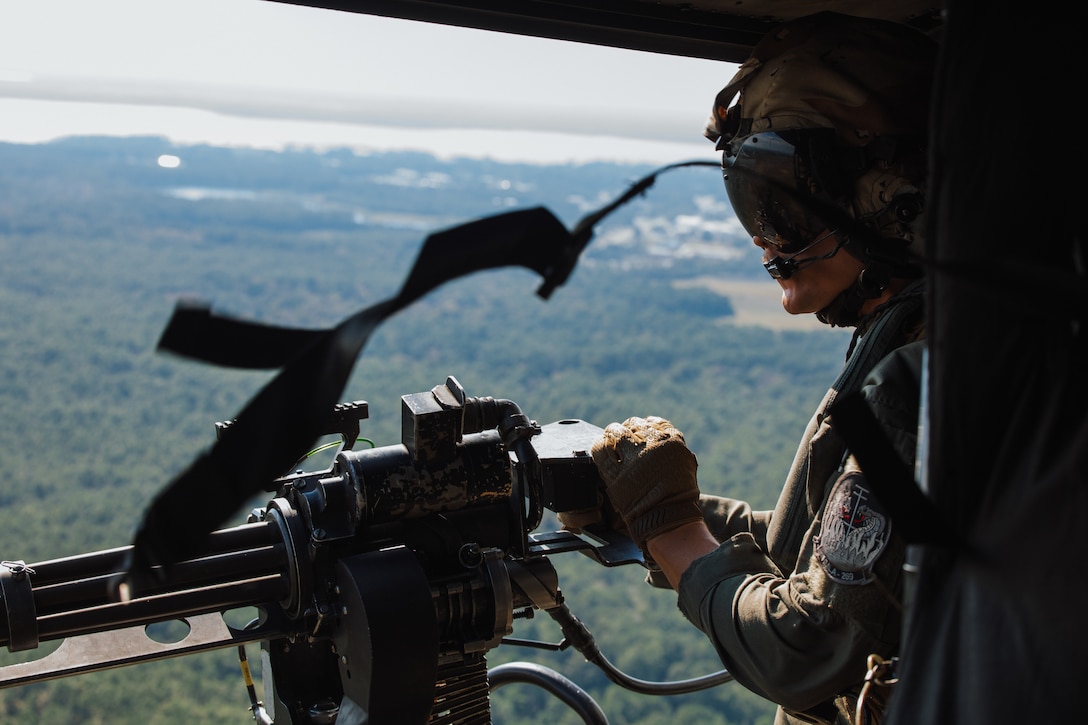 U.S. Marine Corps Sgt. David Hancock, a crew chief with Marine Light Attack Helicopter Squadron (HMLA) 269, Marine Aircraft Group 29, 2nd Marine Aircraft Wing, and a Tennessee native, fires an M-134 minigun from a UH-1Y Venom helicopter assigned to HMLA-269 during close air support training for exercise UNITAS 2025 at Marine Corps Base Camp Lejeune, North Carolina, Sept. 18, 2025. UNITAS, which is Latin for “unity,” was conceived in 1959 and has taken place annually since first conducted in 1960. This year marks the 66th iteration of the world’s longest running annual multinational maritime exercise. The exercise trains forces in joint maritime operations that enhance tactical proficiency and increase interoperability with the presence of unmanned air, surface and submarine systems. (U.S. Marine Corps photo by Sgt. Jorge Borjas)