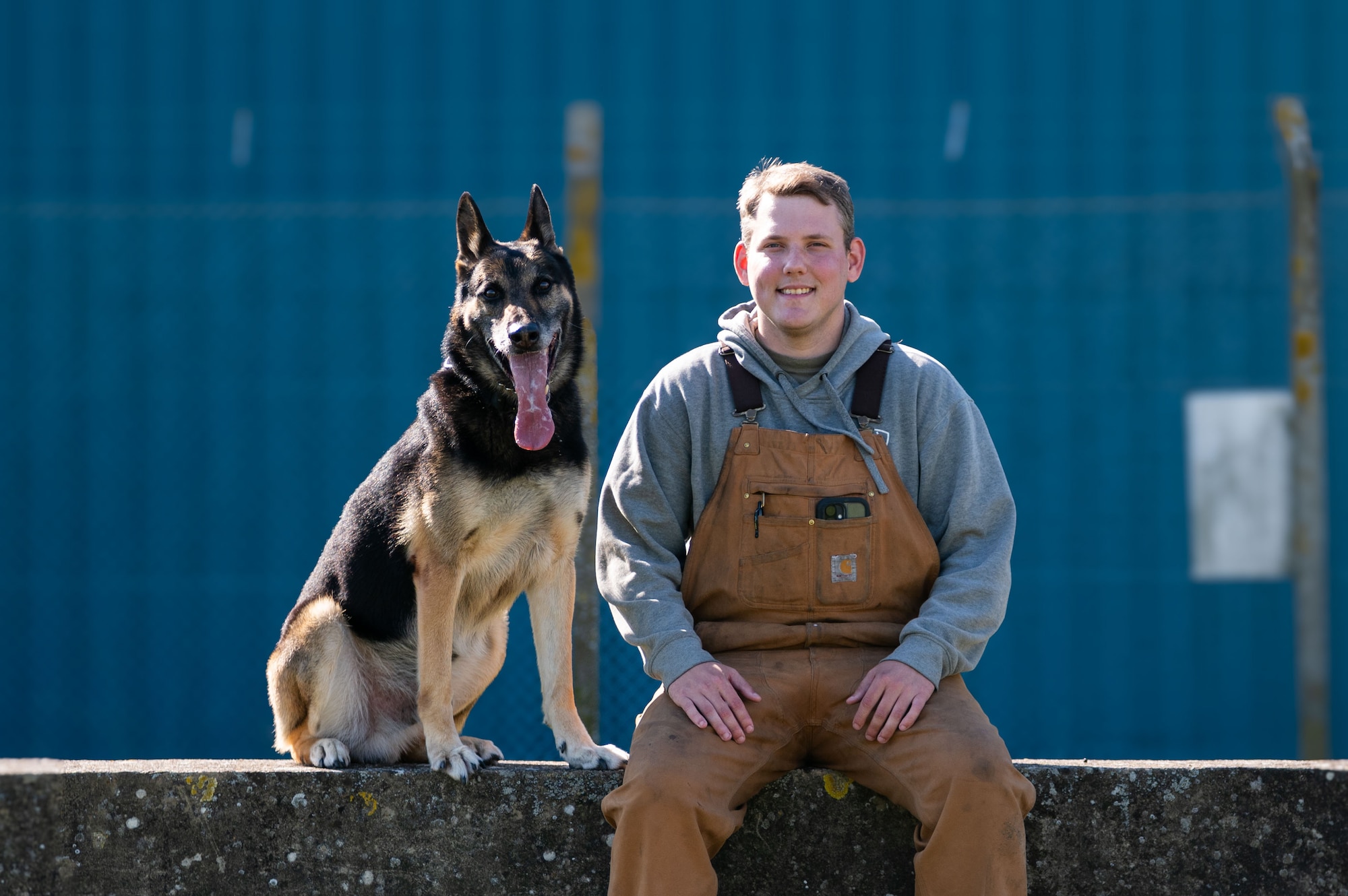 U.S. Air Force Staff Sgt. Cameron Gilbert, 100th Security Forces Squadron Military Working Dog handler, poses with MWD Vantor during routine training at RAF Mildenhall, England, Sept. 19, 2025.