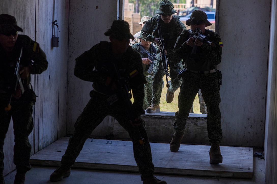 Marines with Infantería de Marina Colombiana (Colombian marines), conduct urban terrain training, during exercise UNITAS 2025 at Marine Corps Base Camp Lejeune, North Carolina, Sept. 19, 2025. UNITAS, which is Latin for “unity,” was conceived in 1959 and has taken place annually since first conducted in 1960. This year marks the 66th iteration of the world’s longest running annual multinational maritime exercise. (U.S. Marine Corps photo by Lance Cpl. Payton Goodrich)