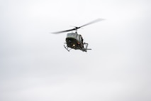 A UH-1 Iroquois assigned to the 54th Helicopter Squadron flies over Sentinel Stadium for the Minot North High School football game in Minot, North Dakota, Sept. 20, 2025. Team Minot leadership delivered the game ball as part of the pre-game ceremonies highlighting the partnership between Team Minot and the local community. (U.S. Air Force photo by Senior Airman Luis Gomez)