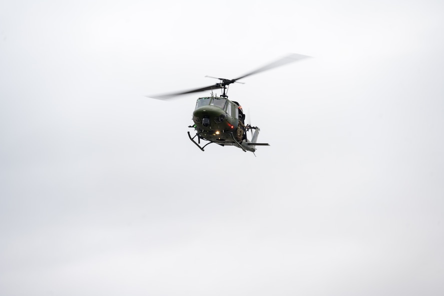A UH-1 Iroquois assigned to the 54th Helicopter Squadron flies over Sentinel Stadium for the Minot North High School football game in Minot, North Dakota, Sept. 20, 2025. Team Minot leadership delivered the game ball as part of the pre-game ceremonies highlighting the partnership between Team Minot and the local community. (U.S. Air Force photo by Senior Airman Luis Gomez)