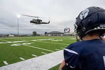 A UH-1 Iroquois assigned to the 54th Helicopter Squadron approaches Sentinel Stadium carrying 5th Bomb Wing and 91st Missile Wing leadership for the Minot North High School football game in Minot, North Dakota, Sept. 20, 2025. Team Minot leadership delivered the game ball as part of the pre-game ceremonies highlighting the partnership between Team Minot and the local community. (U.S. Air Force photo by Senior Airman Luis Gomez)