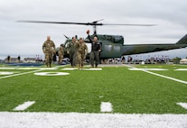 5th Bomb Wing and 91st Missile Wing leadership deliver the game ball at Sentinel Stadium for the Minot North High School football game in Minot, North Dakota, Sept. 20, 2025. The pre-game ceremony highlights the partnership between Team Minot and the local community. (U.S. Air Force photo by Senior Airman Luis Gomez)