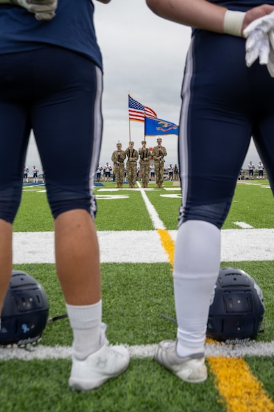 Members of the Minot Air Force Base Honor Guard present the colors before the start of a Minot North High School football game at Sentinel Stadium, Minot, North Dakota, Sept. 20, 2025. As part of the pre-game ceremonies, the 5th Bomb Wing and 91st Missile Wing leadership participated in a UH-1 Iroquois bosslift and delivered the game ball to officials. (U.S. Air Force photo by Senior Airman Luis Gomez)