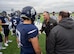 Col. Jesse Lamarand, 5th Bomb Wing commander, shakes hands with a Minot North High School football player prior to the homecoming game at Minot, North Dakota, Sept. 20, 2025. Leaders from the 5th BW and 91st Missile Wing participated in pre-game ceremonies to deliver the game ball. (U.S. Air Force photo by Senior Airman Luis Gomez)