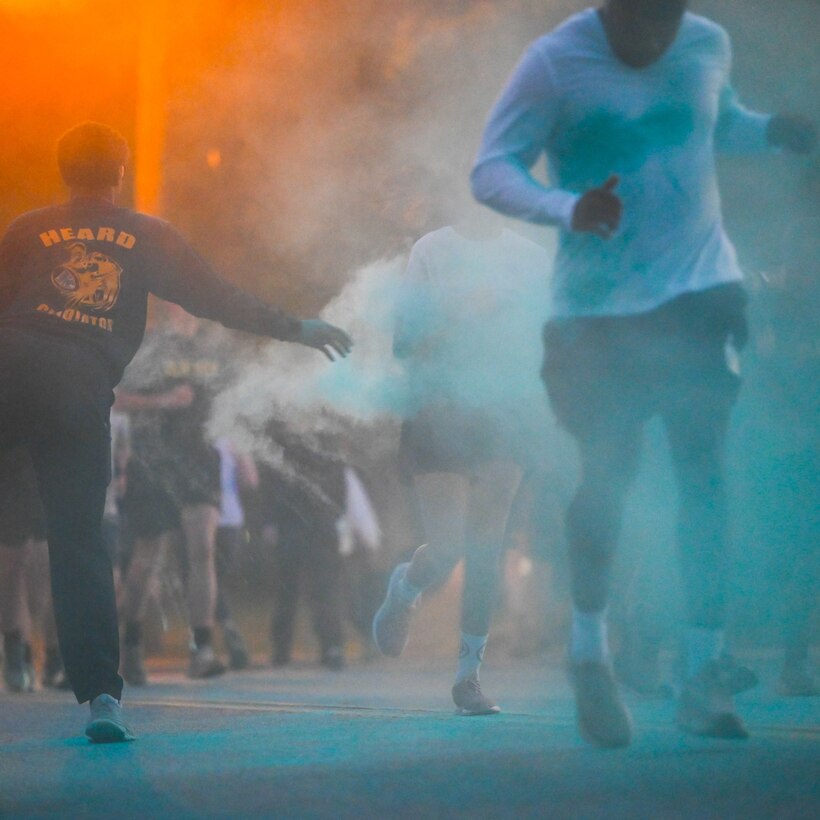Participants run through colored powder.