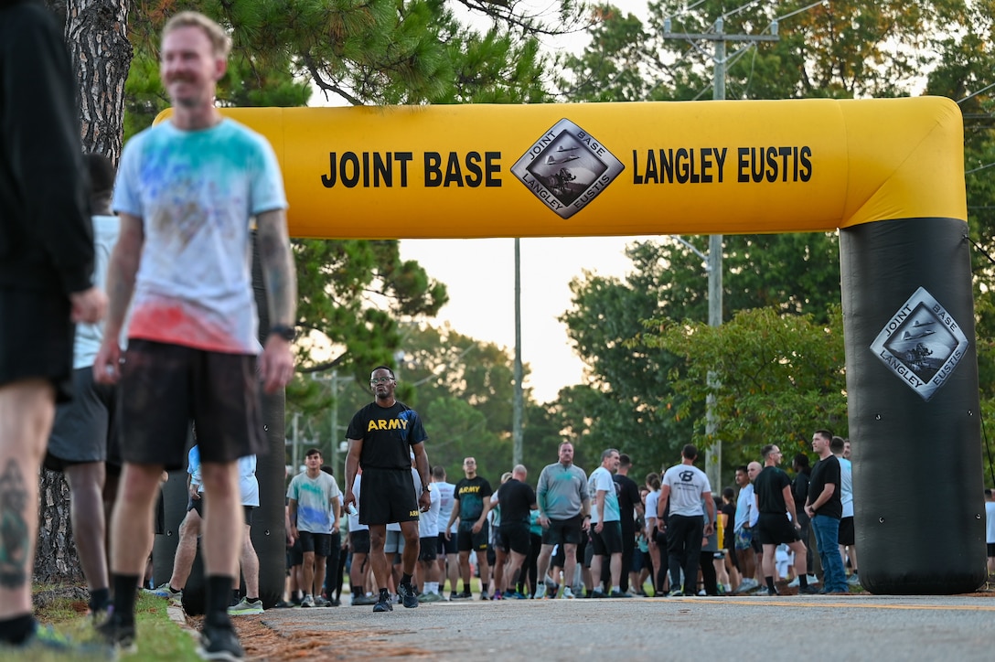 Participants stand beneath the finish line.