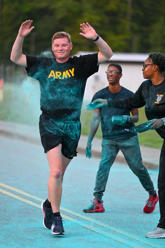 A U.S. Army Soldier is doused in blued powder.