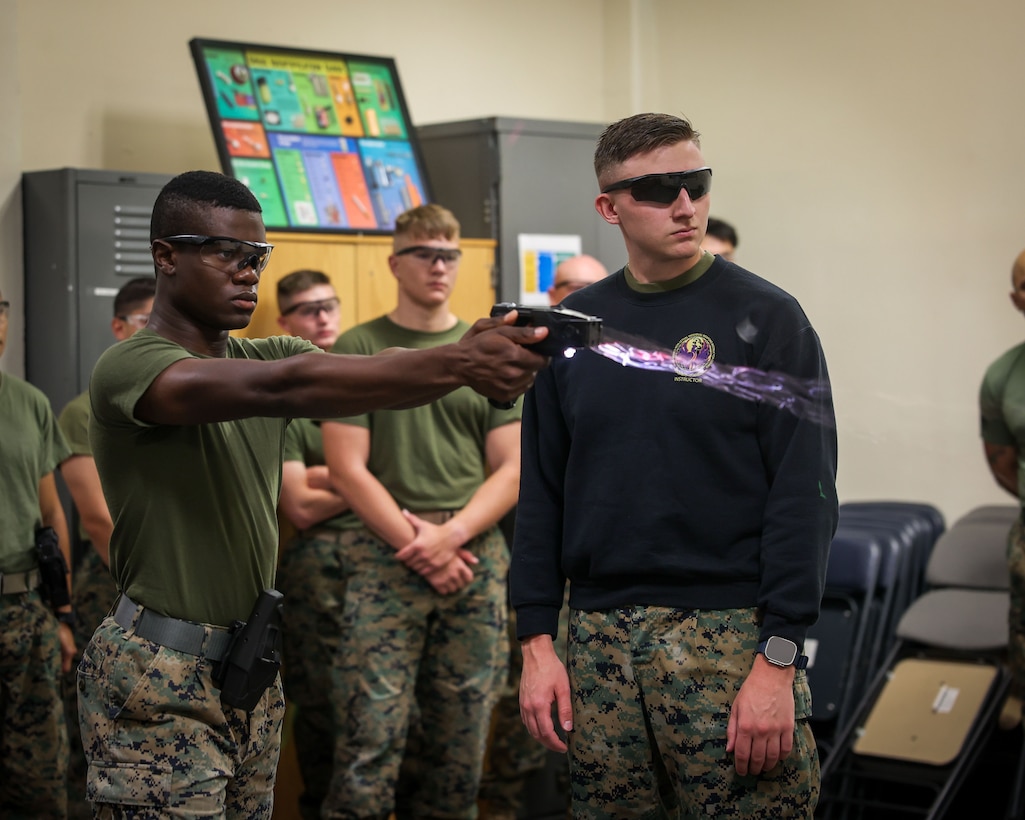 U.S. Marine Corps Lance Cpl. Melvin Fradiue, a student with the Guard Academy, Guard Company, Marine Barracks Washington, conducts taser qualification in Washington, D.C., June 19, 2025. The training certifies Marines in the proper use and effects of non-lethal force as part of their law enforcement responsibilities. (U.S. Marine Corps photo by Lance Cpl. Brynn L. Bouchard)
