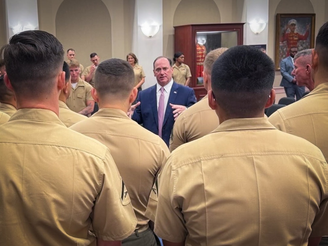 Secretary of the Navy, John Phelan, speaks with Marines after awarding Marine Barracks Washington mascot, Cpl. Chesty XVI, the Navy and Marien Corps Good Conduct Medal at Marine Barracks, Washington, Aug. 12, 2025. The ceremony recognized Chesty XVI’s exemplary behavior and role in representing the Marine Corps during official events and ceremonies. As the official mascot, Chesty plays a key role in bolstering morale and upholding Marine Corps tradition. (U.S. Navy photo by MC2 Jorden Namgyal)