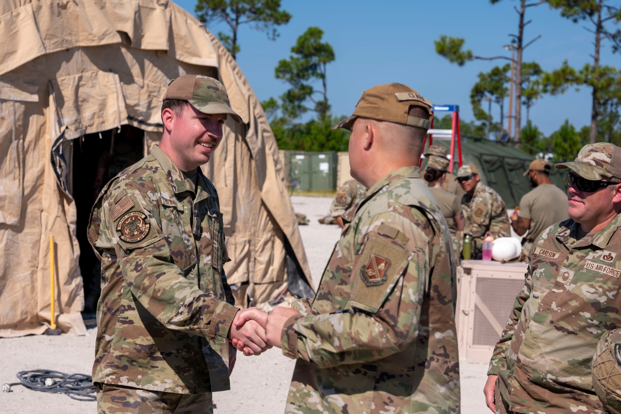 U.S. Air Force Col. James M. Clark, commander of Joint Base Anacostia-Bolling and the 11th Wing, recognizes Staff Sgt. Robert Stinson, a contracting specialist  from the 11th Contracting Squadron, during a combat service support team training at Tyndall Air Force Base, Fla., Sept. 15, 2025.