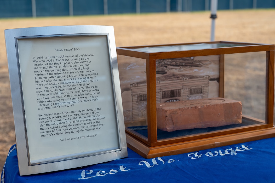 A construction brick recovered in 1993 from the Hòa Lò Prison is displayed during the 2025 POW/MIA ceremony at Mathis Field, Goodfellow Air Force Base, Texas, Sept. 18, 2025. U.S. Prisoners-Of-War in North Vietnam referred to the various jungle prisons as the “Hanoi Hilton”. (U.S. Air Force photo by Senior Airman Quatasia Carter)