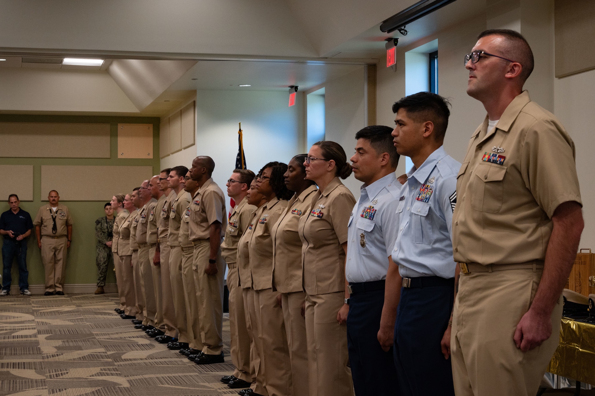 U.S. Navy Sailors and two U.S. Air Force Airmen prepare to be pinned at a Chief Petty Officer pinning ceremony at Joint Base McGuire-Dix-Lakehurst, N.J. Sept. 13, 2025. This time-honored tradition signified the shift in responsibilities for service members as they became subject matter experts to mentor junior enlisted service members.