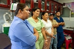 Panamanian health professionals listen during a preventive maintenance class at the Centro de Salud de La Mesa, Panama, Sept. 18, 2025. As part of AMISTAD 2025, a U.S. Air Force heating, ventilation, air conditioning and refrigeration technician, partnered with a Language Enabled Airman Program translator to teach clinic staff basic preventive maintenance techniques to keep newly installed air-conditioning units running long after U.S. teams depart. (U.S Air Force photo bt Andrea Jenkins)