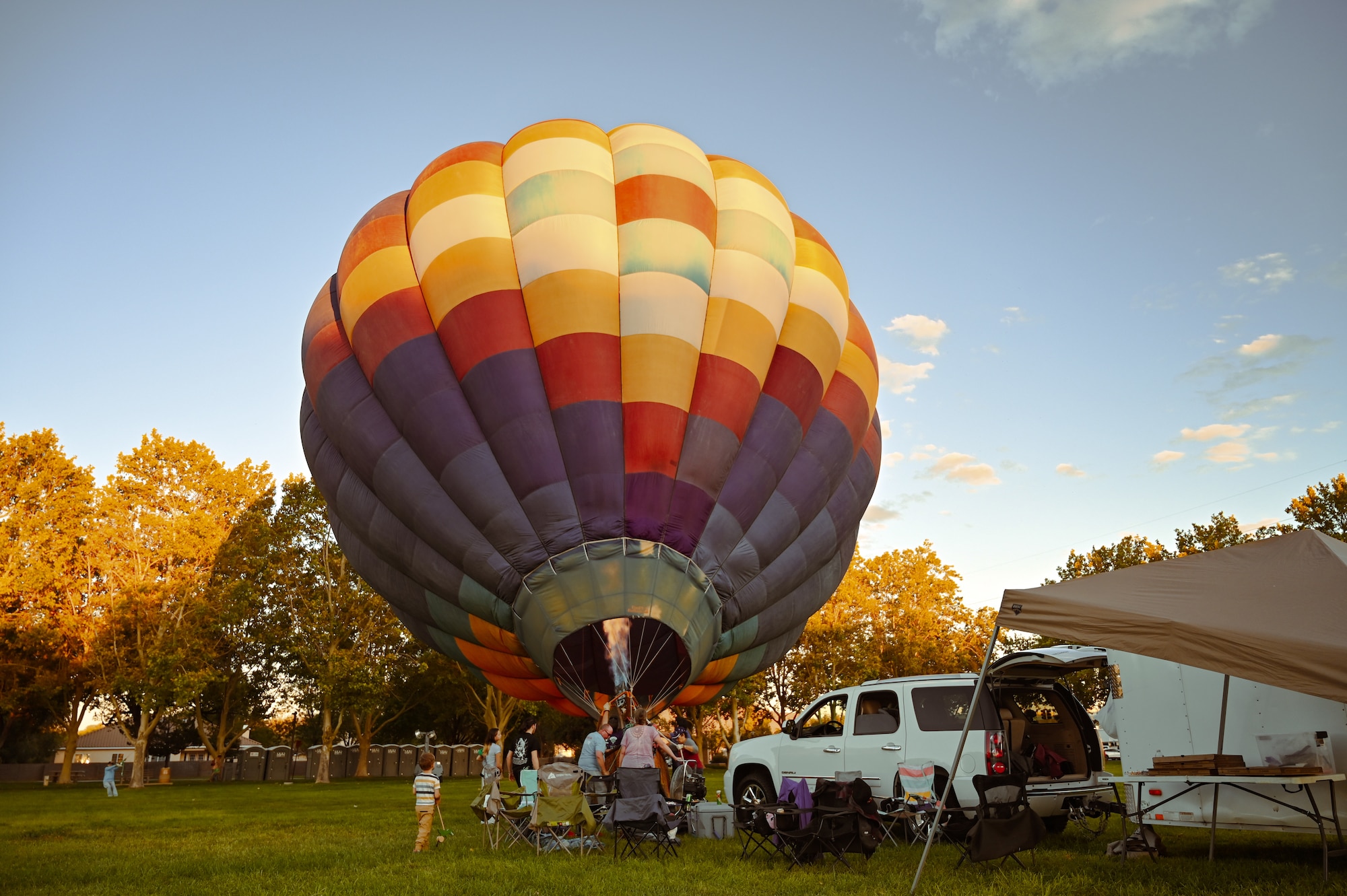 Families gather around a hot air balloon