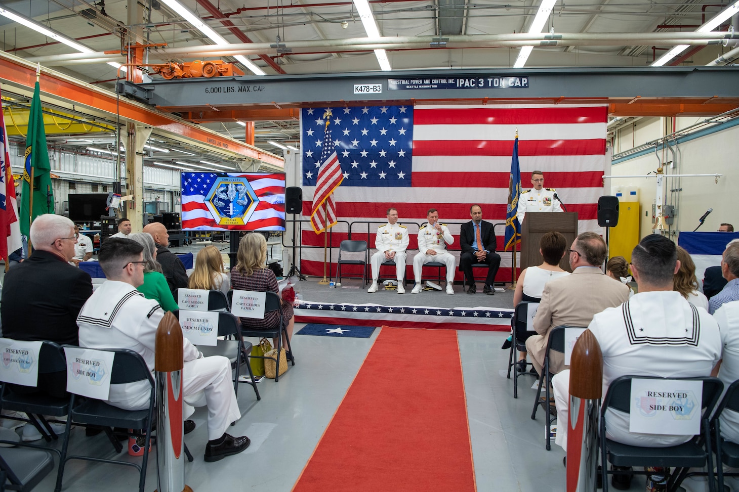 Capt. Michael Dolbec, commander, Unmanned Undersea Vehicle Group (UUVGRU) 1, unveils the command’s new logo during a change of command ceremony at Naval Base Kitsap-Keyport, Wash., June 14, 2024. During the ceremony, Dolbec relieved Capt. Jason Geddes as commander, UUVGRU 1. (U.S. Navy photo by Mass Communication Specialist 2nd Class Victoria Galbraith)