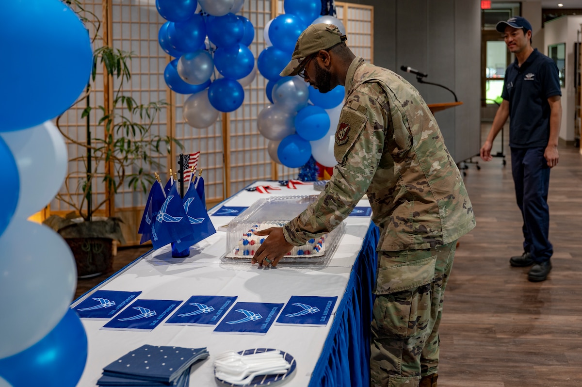 U.S. Air Force Staff Sgt. Kayce Swanigan, 35th Force Support Squadron dining facility storeroom noncommissioned officer in charge, places a cake on a table in preparation of a 78th Air Force birthday celebration at Misawa Air Base, Japan, Sept. 18, 2025.