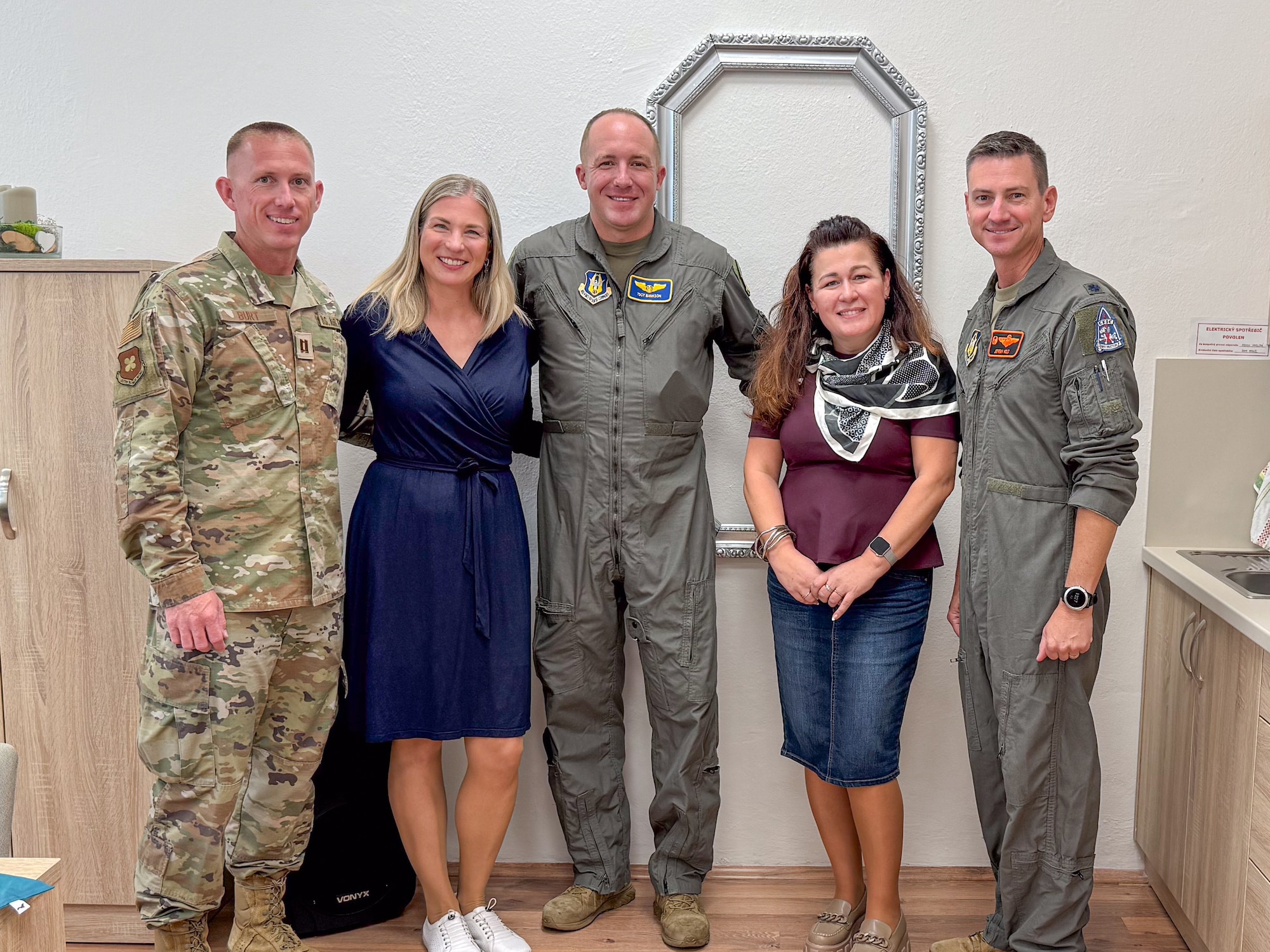 U.S. Air Force Lt. Col. Jeremy Holt, 343rd Bomb Squadron Commander, Capt. Cody Burt, 307th Bomb Wing Public Affairs Officer, and Master Sgt. Christopher Bankson, 307th Bomb Wing avionics specialist, pose for a group photo with staff from a local school in Ostrava, Czech Republic. These visits strengthen community ties with NATO Allies and partners and coincide with the NATO Days air show in Ostrava, Czech Republic. (Courtesy photo by Kryštof Friedel)