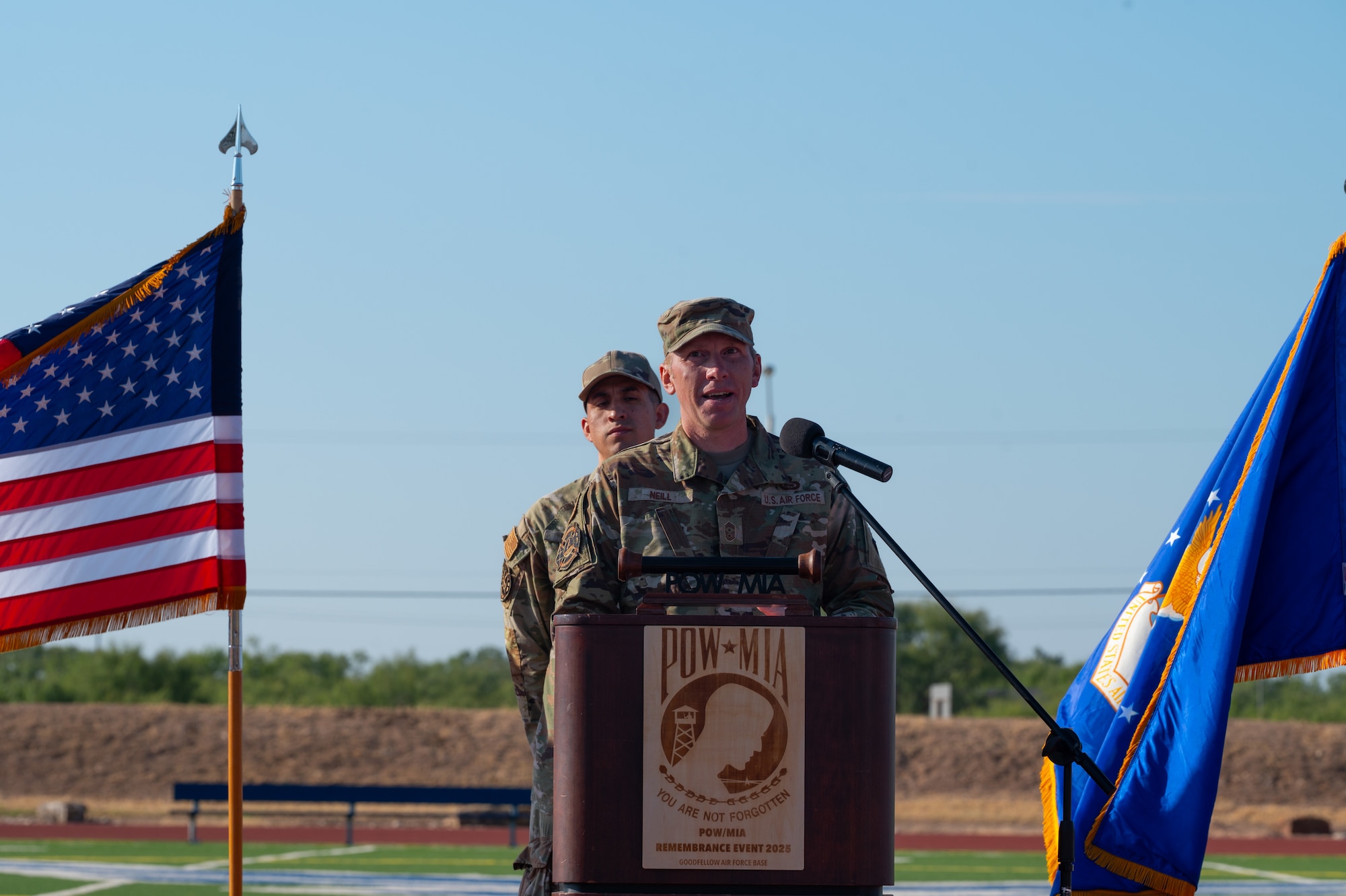U.S. Air Force Chief Master Sgt. Derek Neill, 17th Training Wing command chief, delivers closing remarks, wrapping up the 2025 POW/MIA 24-hour run at Mathis Field, Goodfellow Air Force Base, Texas, Sept. 19, 2025. “With events like these where we pause to reflect and recognize the sacrifice of military professionals and warriors that paved the way for us,” said Neill. “I try to determine what we can learn and how we can use their experience to make us more resilient. (U.S. Air Force photo by Senior Airman Quatasia Carter)