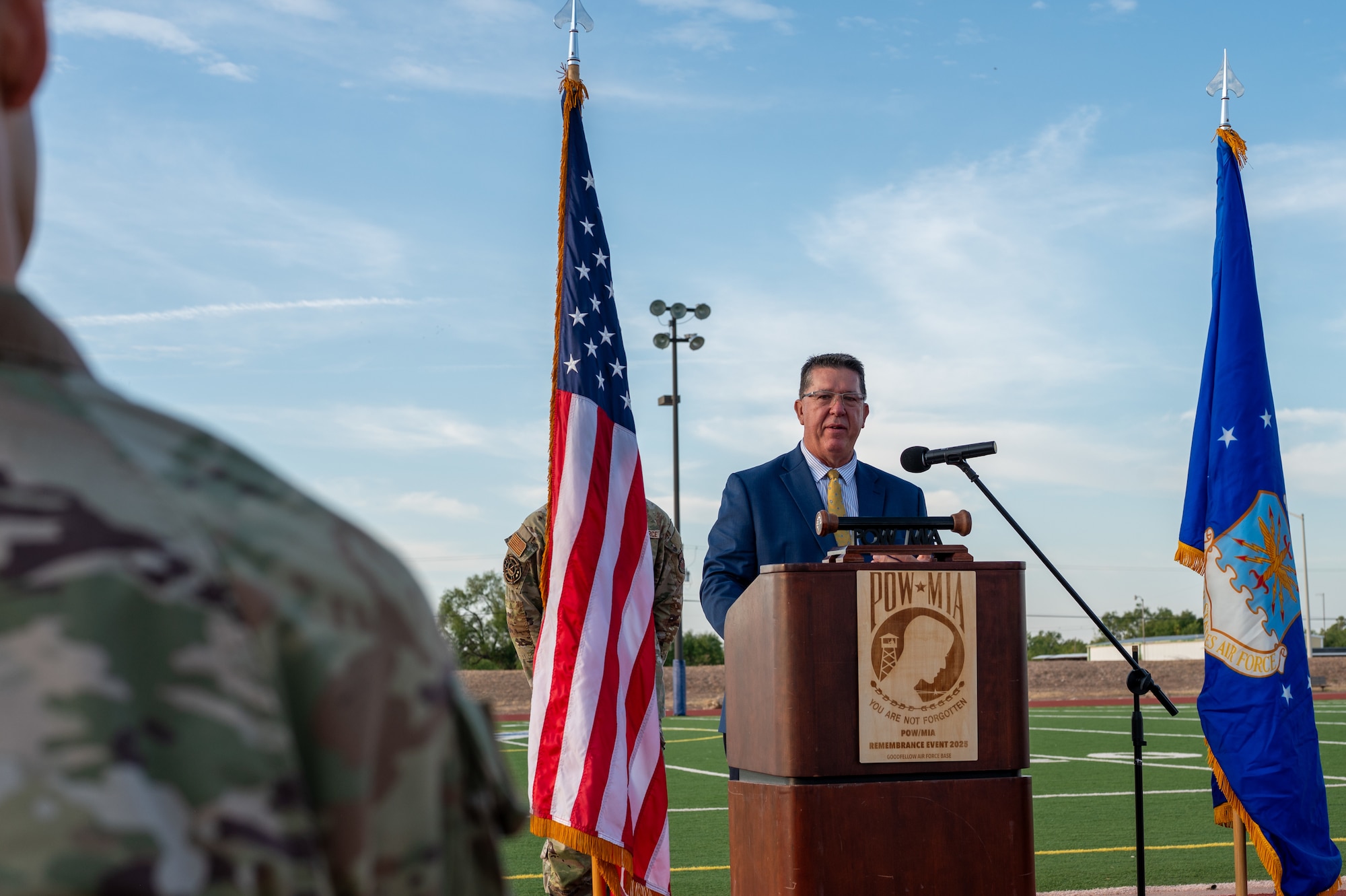 San Angelo Mayor Tom Thompson details the meaning represented by the colors of the POW/MIA flag during the 2025 POW/MIA Vigil opening ceremony Goodfellow Air Force Base, Texas, Sept. 18, 2025. “The black background reflects the sorrow of loss,” said Thompson. “The white lettering the hope of return, and the silhouette represent the men and women who stand to watch in their memory.” (U.S. Air Force photo by Senior Airman Quatasia Carter)
