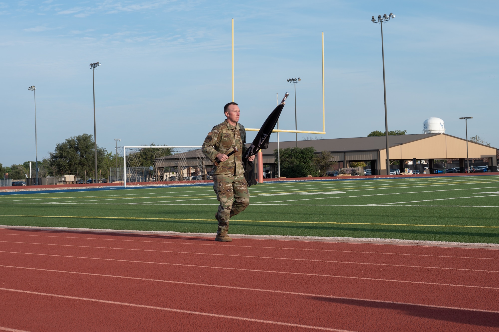 U.S. Air Force Chief Master Sgt. Derek Neill, 17th Training Wing command chief, kicks off the 2025 POW/MIA Vigil at Mathis Field, Goodfellow Air Force Base, Texas, Sept. 18, 2025. “At any time, we may be called into action to go exercise the incredible strength of our joint force, and we must be ready,” said Neill during the opening remarks. (U.S. Air Force photo by Senior Airman Quatasia Carter)