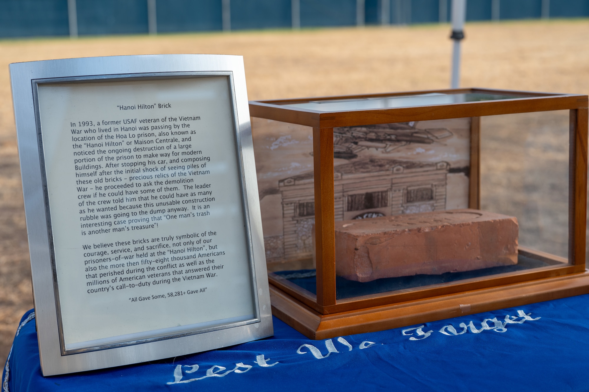 A construction brick recovered in 1993 from the Hòa Lò Prison is displayed during the 2025 POW/MIA ceremony at Mathis Field, Goodfellow Air Force Base, Texas, Sept. 18, 2025. U.S. Prisoners-Of-War in North Vietnam referred to the various jungle prisons as the “Hanoi Hilton”. (U.S. Air Force photo by Senior Airman Quatasia Carter)