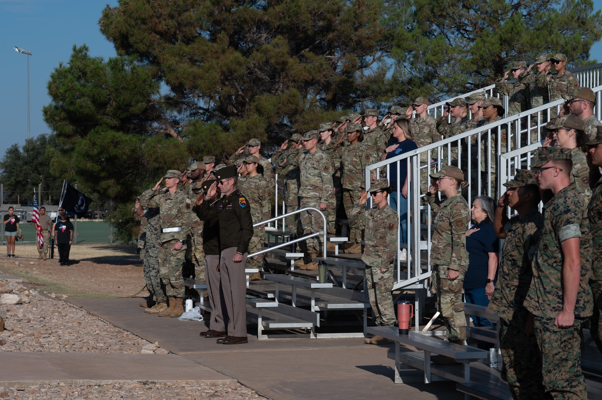 Members of the 17th Training Wing salute the flag during the 2025 POW/MIA 24-hour run closing ceremony at Mathis Field, Goodfellow Air Force Base, Texas, Sept. 19, 2025. The closing ceremony was one of three events dedicated to National POW/MIA Recognition Day. (U.S. Air Force photo by Senior Airman Quatasia Carter)
