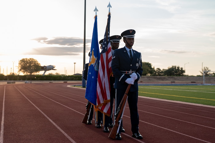 U.S. Air Force Airmen assigned to the 17th Training Wing Base Honor Guard prepare to present the colors on Mathis Field, Goodfellow Air Force Base, Texas, Sept. 18, 2025. The 2025 POW/MIA Vigil opened with the honor guard's presentation of the colors and the singing of the national anthem. (U.S. Air Force photo by Senior Airman Quatasia Carter)