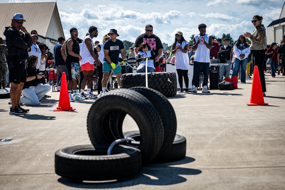 A strongman competition participant pulls four tires during Air Fest 2025.