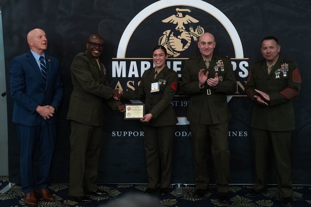 Cpl. Amanda Morenokuan, a food service specialist, with Headquarters and Headquarters Squadron (H&HS), Marine Corps Air Station Iwakuni, and a native of Cuba, is awarded Marine Corps Installations Pacific Marine of the Year during the Marine Corps Association’s (MCA) Iwakuni Professional Dinner at Marine Corps Air Station Iwakuni, Japan, Sept. 13, 2025. The MCA Iwakuni professional dinner recognized a U.S. Sailor and Marine for being Sailor and Marine of the year respectively, the dinner also brought together junior and senior Marines and Sailors to build camaraderie. (U.S. Marine Corps photo by Cpl. Brian Long)