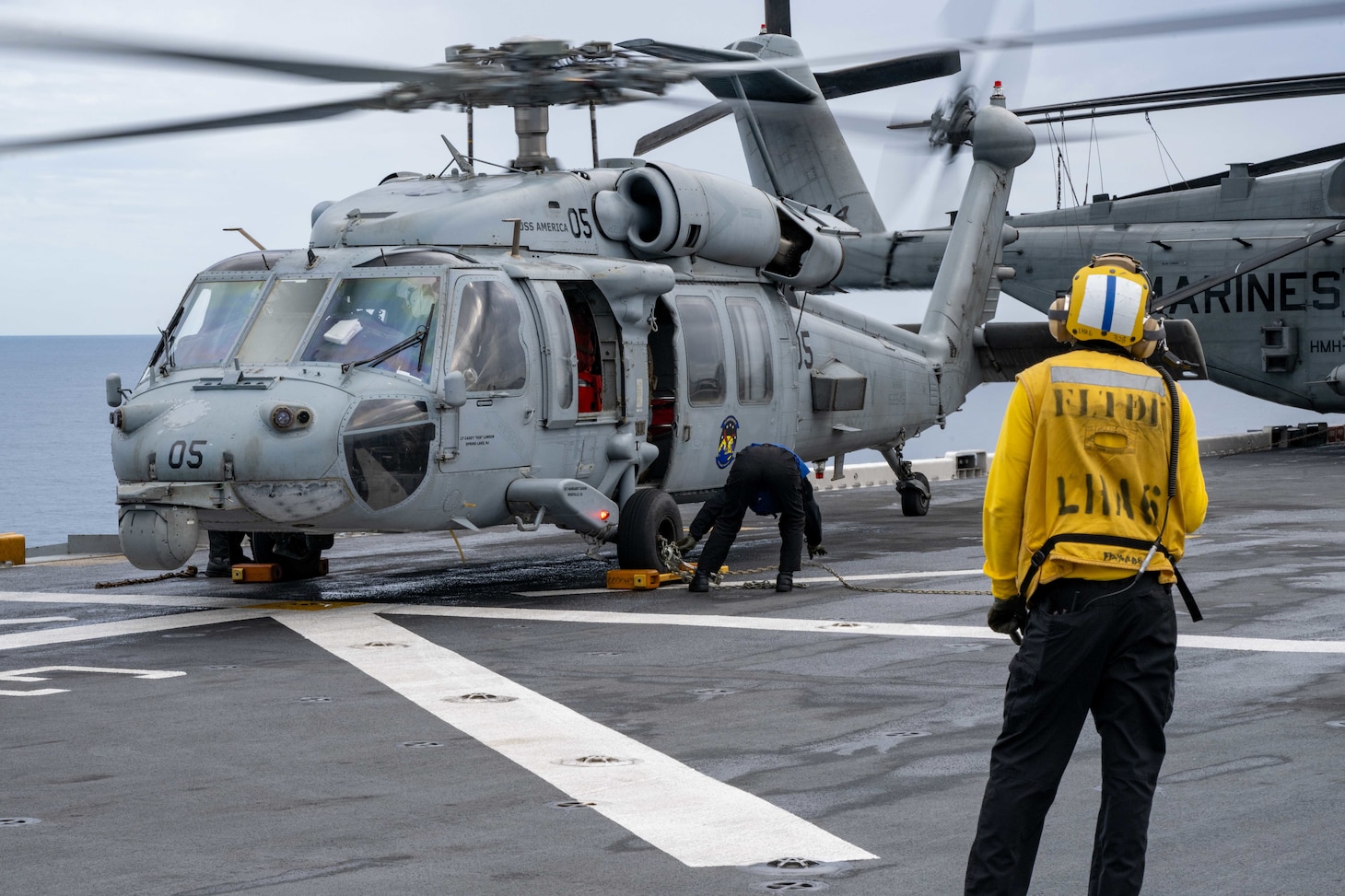 Sailors chock and chain an MH-60S Seahawk from Helicopter Sea Combat Squadron (HSC) 25 to the flight deck of the forward-deployed amphibious assault ship USS America (LHA 6) while conducting flight operations in the Coral Sea, July 7. America, lead ship of the America Amphibious Ready Group, is operating in the U.S. 7th Fleet area of operations. U.S. 7th Fleet is the U.S. Navy’s largest forward-deployed numbered fleet, and routinely interacts and operates with allies and partners in preserving a free and open Indo-Pacific region.