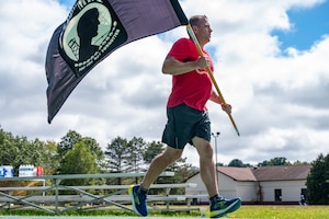 Image of person running with POW/MIA flag.