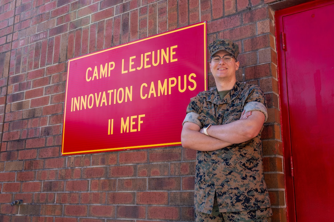 U.S. Marine Corps Cpl. Grant Morris, a digital wideband systems maintainer with 2nd Intelligence Battalion, II Marine Expeditionary Force Information Group, II MEF, poses for a photo at Marine Corps Base Camp Lejeune, North Carolina, Sept. 4, 2025. Morris designed a dust cover for the hand-held radio test set during the additive manufacturing basic course hosted by the II MEF Innovation Campus. The additive manufacturing basic course focuses on providing students with knowledge and access to tools that assist in finding and utilizing reverse engineering, digital part design, and basic 3D printing of polymers. The 3D-printed dust cover provided the Marine Corps a quick and cost-effective solution to protect the communication equipment from dust, sand, wear and tear, extending its service life. Morris is a native of Nevada. (U.S. Marine Corps photo by Lance Cpl. Brady V. Hathaway)