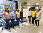 On September 10, art therapist Claire Wetterer (center) and members of the Pediatric Hematology Oncology clinic staff pose for a photo showing off their gold shoes. The Walter Reed National Military Medical Center Pediatric Hem/Onc clinic treats patients aged 2 to 26. (DOD Photo by Ann Brandstadter)