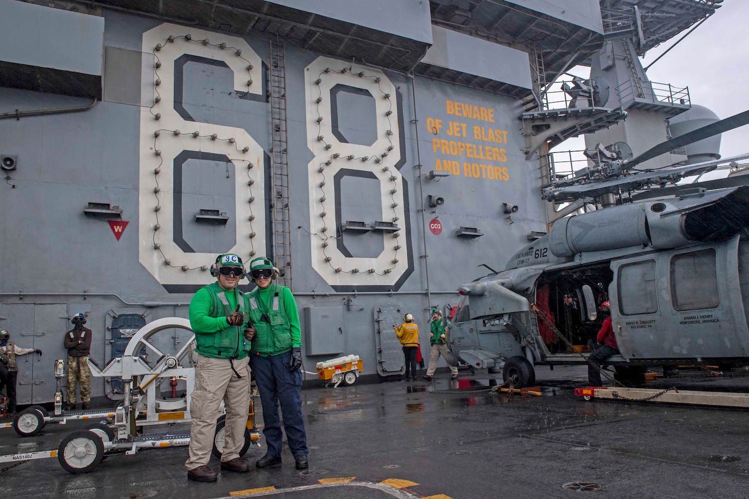 Senior Chief Aviation Machinist's Mate Dan Reyes and his daughter, U.S. Midshipmen 2nd Class Gabriella Reyes, from Miami, Florida, pose for a photo on the flight deck aboard the aircraft carrier USS Nimitz (CVN 68) in the South China Sea, June 11, 2025. Nimitz is underway in the U.S. 7th Fleet area of operations on a scheduled deployment, demonstrating the U.S. Navy's unwavering commitment to a free and open Indo-Pacifi