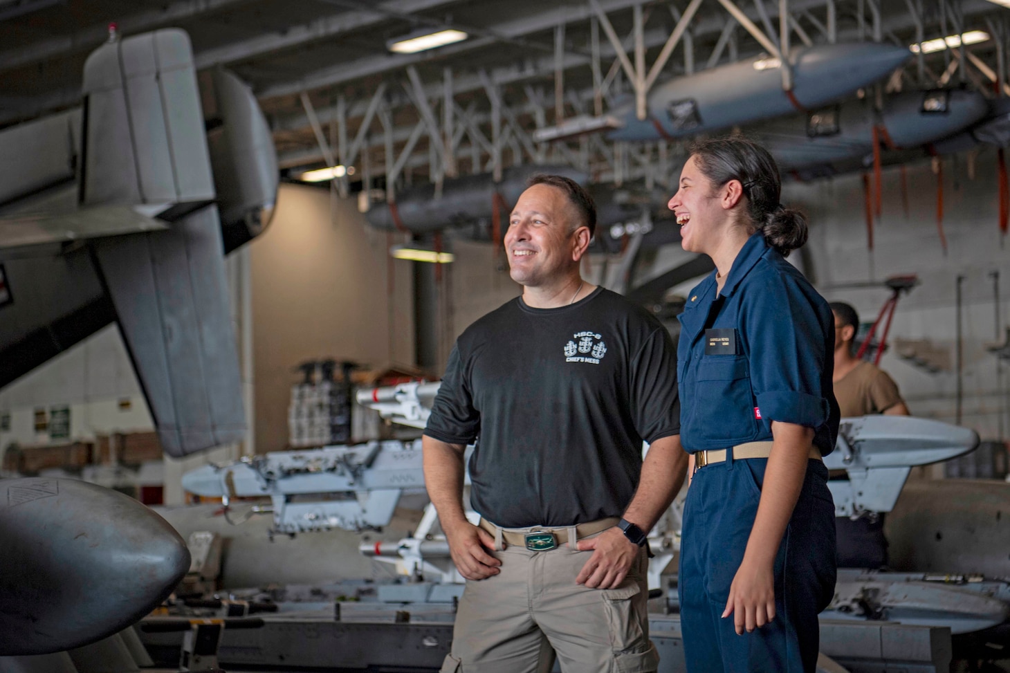 From left, Senior Chief Aviation Machinist's Mate Dan Reyes and his daughter, U.S. Midshipmen 2nd Class Gabriella Reyes, from Miami, Florida talk in the Hanger Bay of the aircraft carrier USS Nimitz (CVN 68) in the South China Sea, June 10, 2025. Nimitz is underway in the U.S. 7th Fleet area of operations on a scheduled deployment, demonstrating the U.S. Navy's unwavering commitment to a free and open Indo-Pacific.