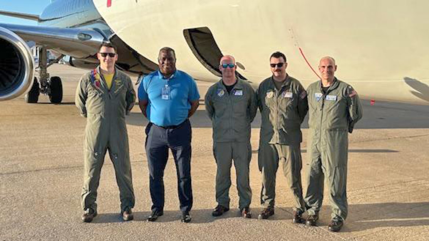 E-6B aircrew celebrate a successful first Public Air Operations training flight, showcasing the Navy's commitment to innovative solutions for maintaining peak readiness. Pictured left to right: Cmdr. Nathaniel Whitman, Fleet Air Reconnaissance Squadron SEVEN (VQ-7) executive officer; Marc Thomason, AAR E-6B in-flight trainer chief pilot; Senior Chief Jake Perry, VQ-7 flight engineer; Chief Charles Breen, VQ-7 flight engineer; and Capt. Zach Brown, SCW-1 prospective deputy wing commander.