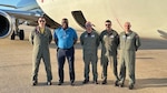 E-6B aircrew celebrate a successful first Public Air Operations training flight, showcasing the Navy's commitment to innovative solutions for maintaining peak readiness. Pictured left to right: Cmdr. Nathaniel Whitman, Fleet Air Reconnaissance Squadron SEVEN (VQ-7) executive officer; Marc Thomason, AAR E-6B in-flight trainer chief pilot; Senior Chief Jake Perry, VQ-7 flight engineer; Chief Charles Breen, VQ-7 flight engineer; and Capt. Zach Brown, SCW-1 prospective deputy wing commander.