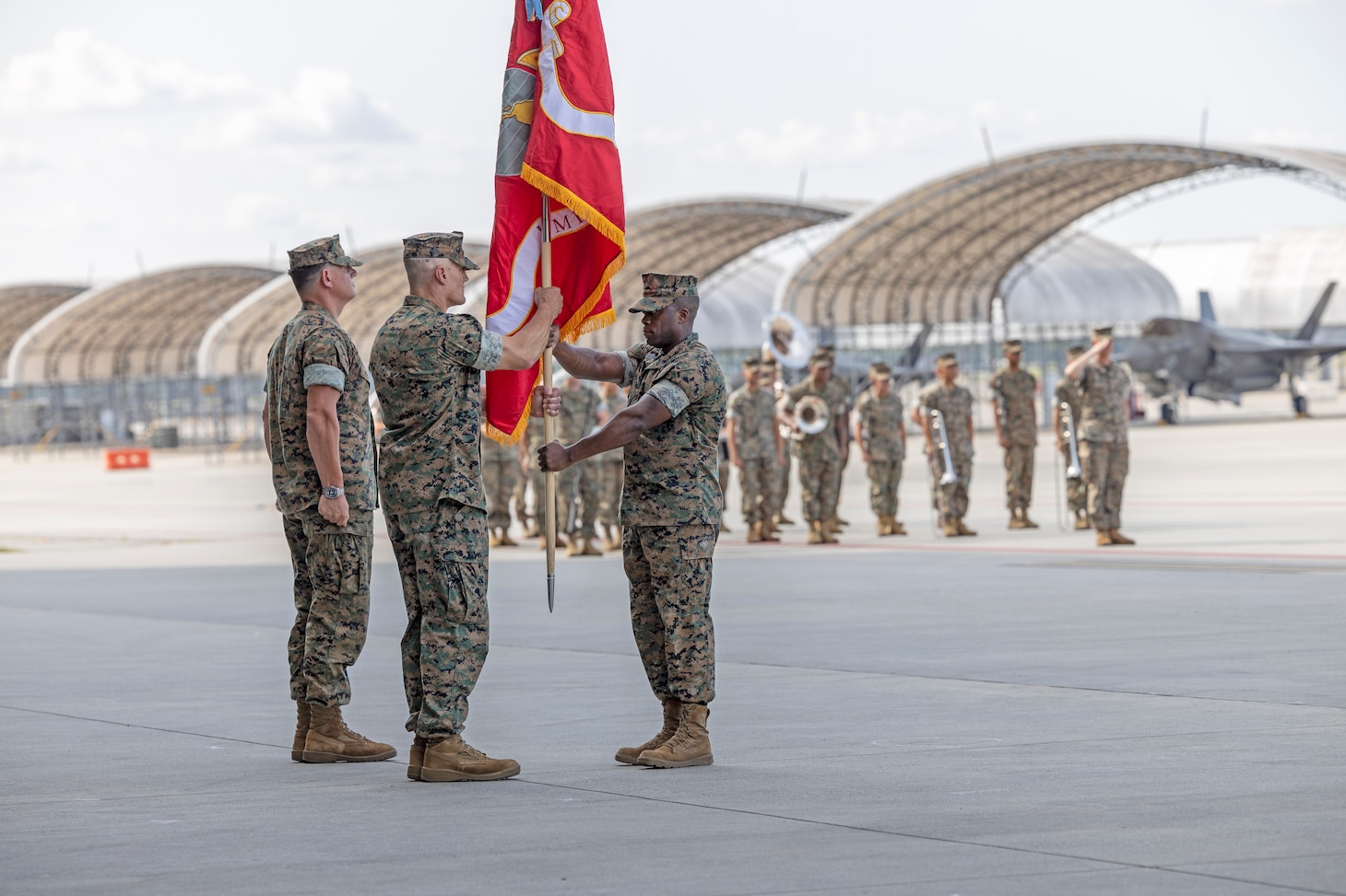 U.S. Marine Corps Sgt. Maj. Steven E. Buckom, from North Carolina, command senior enlisted leader, Marine All-Weather Fighter Attack Squadron (VMFA(AW)) 224, passes the Marine Corps colors to Lt. Col. Jarrod Allen, from California, the outgoing commanding officer of VMFA(AW)-224, during a squadron redesignation and change of command ceremony at Marine Corps Air Station Beaufort, South Carolina, June 26. The ceremony represented the squadron's transition from an all-weather F/A-18D Hornet squadron to an F-35B Lightning II squadron and signified the transfer of responsibility, authority, and accountability from Allen to Lt. Col John P. Stuart.