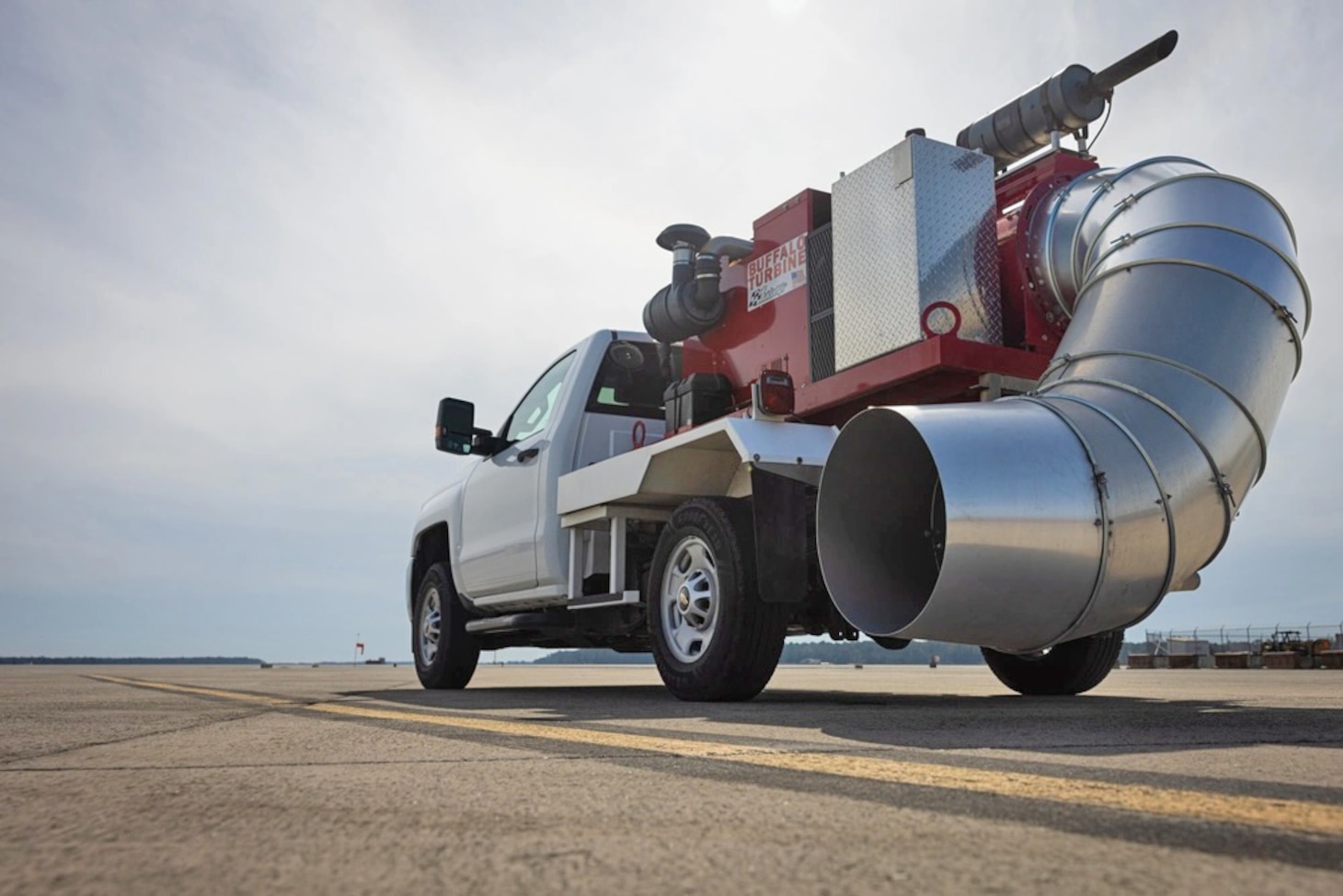 A truck affixed with a foreign object debris blower is staged on 
the airfield at Marine Corps Air Station Cherry Point, N.C., Feb. 25. FOD blowing uses equipment to clear debris from runways and airfields, ensuring the safety and efficiency of  aviation operations.