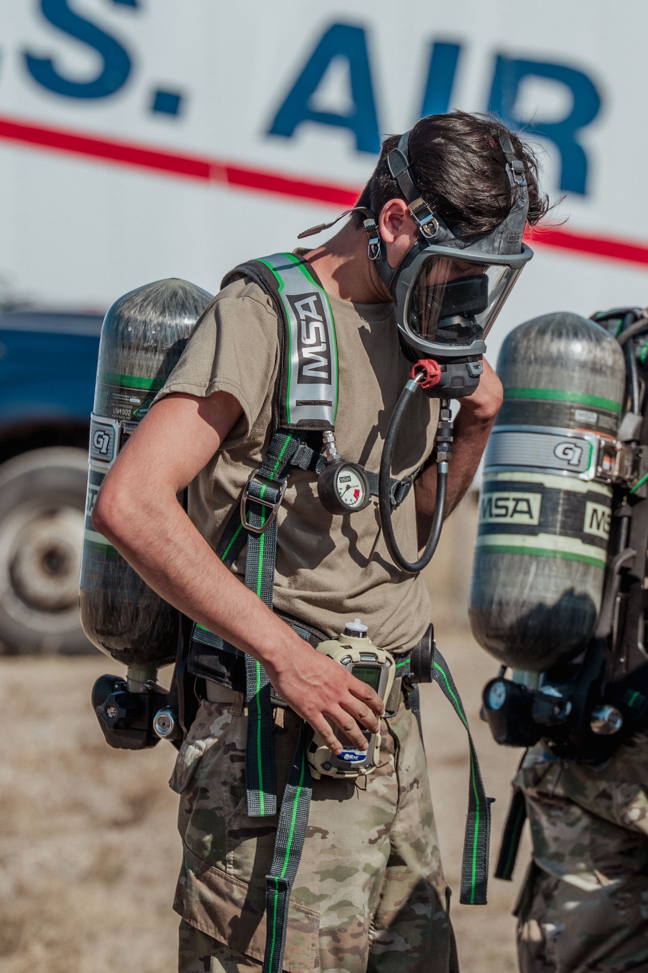 A man wearing a gas mask and an oxygen tank.